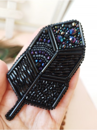 Black feather embroidery brooch.